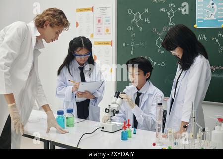 Students Conducting Scientific Experiment in Laboratory Setting Stock Photo