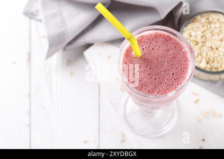 Strawberry milkshake or smoothie with oatmeal in a glass, top view copy space Stock Photo