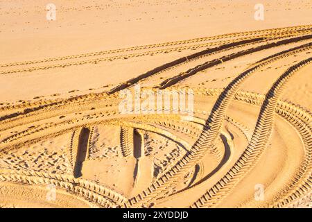 Aerial view of multiple tire tracks imprinted on golden sand on a portuguese beach albufeira portugal Stock Photo