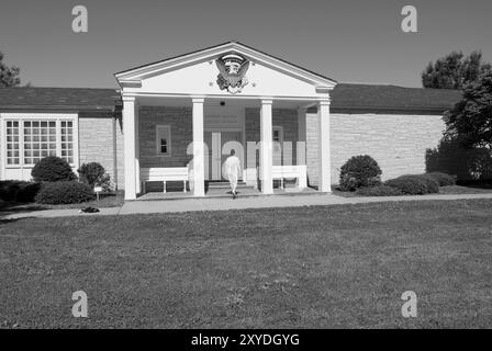 Caucasian woman (55 to 60 years) entering the Herbert Hoover Presidential Library Museum in West Branch, Iowa, USA. Stock Photo