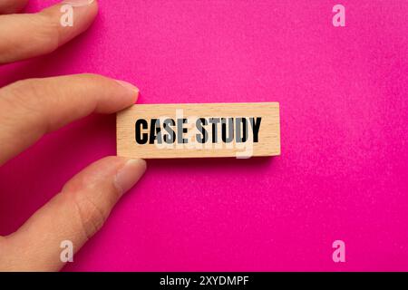 Case study message written on wooden block with pink background. Conceptual case study symbol. Copy space. Stock Photo