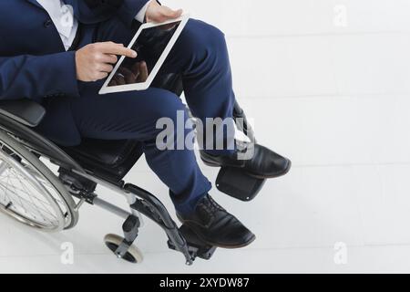 Close up businessman s hand wheel wheelchair Stock Photo