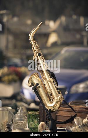 Golden saxophone on a flea market, outdoors Stock Photo