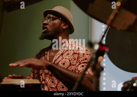 Bearded Man Singing While Playing Conga Stock Photo