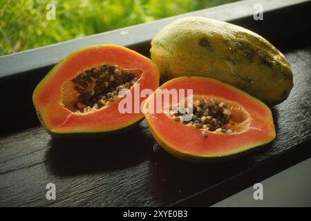 Varieties of tropical fruit, ripe Hawaiian papaya or Solo papaya on a wooden bar table Stock Photo