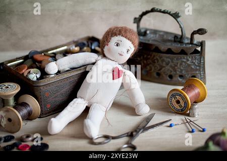 Simple old rag doll with attached red heart Stock Photo - Alamy