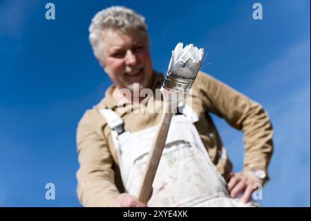 Craftsman with a paintbrush in his hand Stock Photo