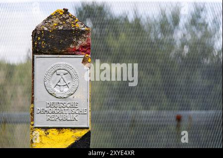 Old border post in front of a border fence on the former inner-German border Stock Photo