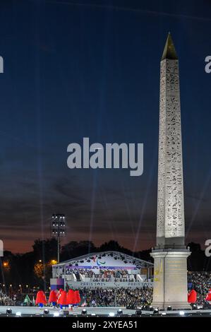 The Luxor Obelisk, centrepiece of the Place de la Concorde lit up during the opening Ceremony of the Paris 2024 Paralympic Games, at Place de la Concorde.  Para athletes from 168 delegations paraded around the largest square in Paris, which was transformed for one evening only into a magnificent open-air arena.  At the end of the ceremony, there were fireworks and the Paris 2024 Cauldron was lit once again returning to the skies over Paris. Stock Photo