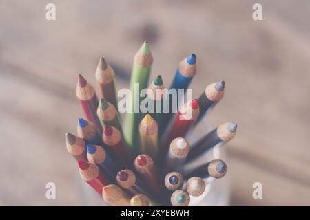 Colored pencils in a can on rustic wooden table Stock Photo