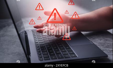 Laptop with hologram warning sign for notification error. Programmer, developer and maintenance system concept. Scam virus attack. Security protection. Stock Photo