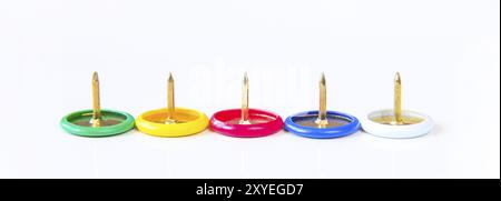 Business office stress problems concept. Colorful macro close up thumbtacks or push pins in a row on white background with pins up Stock Photo