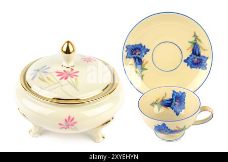 Vintage porcelain tableware: small coffee cup with saucer and elegant candy bowl isolated on white background. Collage. Stock Photo