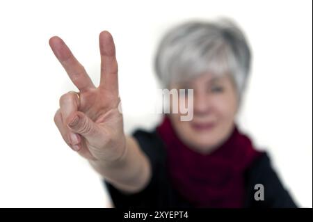 Woman shows the Victory sign Stock Photo