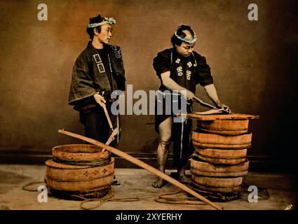 Itinerant Fish Sellers 1880  by Usui Shuzaburo . Japanese hand-coloured black and white photo Japan late 19th - beginning of 20th-century vintage albumen photograph ( Historic History ) digital improved reproduction. Stock Photo