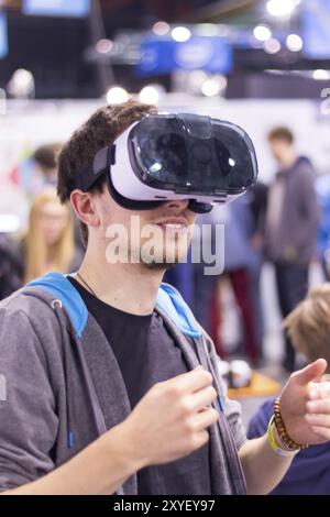 Young man is using virtual reality glasses on an expo Stock Photo