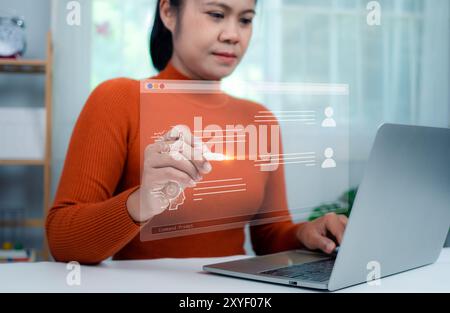 Woman hand holding a stylus pen touching a virtual screen displaying questions and answers with artificial intelligence, Machine learning, AI technolo Stock Photo