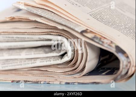 A pile of old yellowed daily newspapers Stock Photo