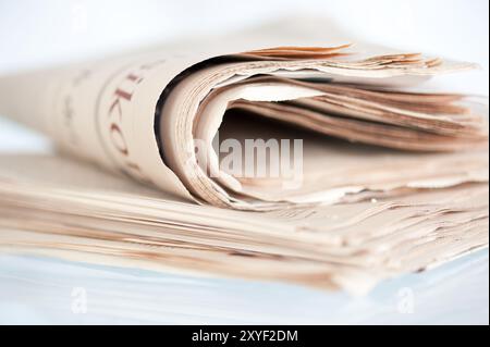 A pile of old yellowed daily newspapers Stock Photo