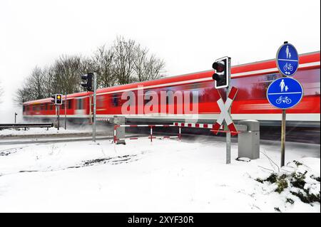 Red passenger train in winter Stock Photo