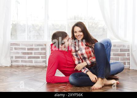 Couple in love at home relaxing on the floor Stock Photo