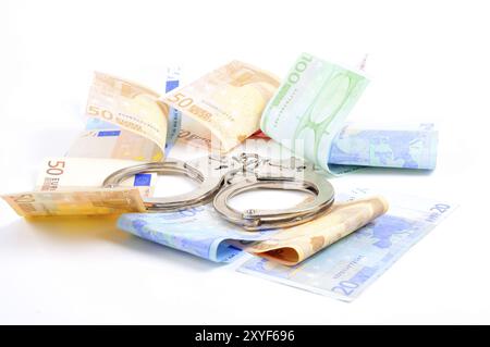 Handcuffs and money on a table, Handcuffs and banknotes Stock Photo