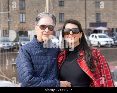 Lossiemouth,Scotland. 29th August, 2024. John W Heny II and wife Linda Pizzuti arrive at Lossiemouth harbour with family, and talk to Liverpool FC fans at the harbour Stock Photo