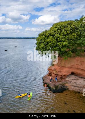 Lympstone, UK. 29th Aug, 2024. People kayaking off the coast of Lympstone near Exeter in Devon with the last of the summer weather. Credit: Thomas Faull/Alamy Live News Stock Photo