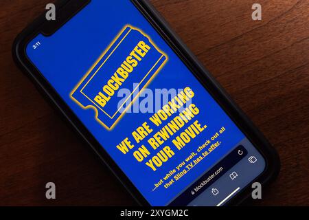 Website of Blockbuster seen in an iPhone. Blockbuster was a leading video rental chain in 90s, before declining due to the rise of streaming services Stock Photo