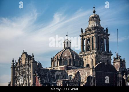 MEXICO CITY, Mexico — The Sagrario Metropolitano and Catedral Metropolitana, viewed from the excavated ruins of the Templo Mayor. This striking juxtaposition showcases Mexico City's layered history, with colonial-era Catholic structures rising above the remnants of the Aztec empire's main temple. Stock Photo