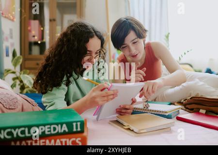 Studying Together in Cozy Bedroom Environment Stock Photo