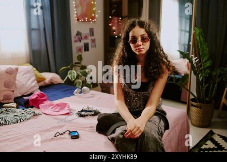 Portrait of Young Woman Posing in Cozy Bedroom Setting Stock Photo