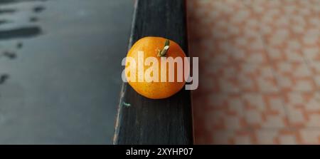 Fresh Sicilian oranges, mandarins on black iron background Stock Photo
