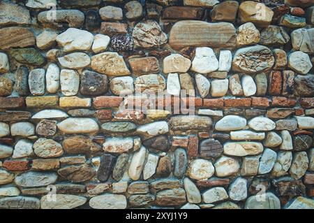 Ancient variegated stone wall Stock Photo
