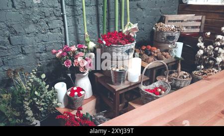From above of arranged pots vases and wicker baskets with assortment of colorful flowers and plants in modern shop Stock Photo