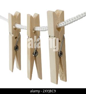 Den Helder, Netherlands. July 2022. Wooden clothes pegs on a white background, isolated. Selective focus Stock Photo