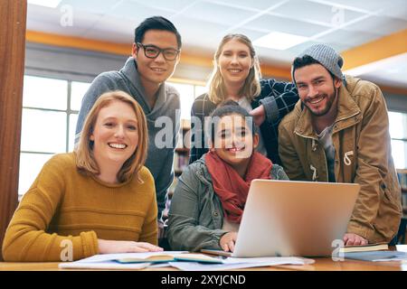 Laptop, portrait and people in library for study with university, education and scholarship in learning together. Books, online research and students Stock Photo
