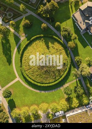 Aerial view of a circular Celtic burial mound in a green park, surrounded by trees and houses, Nagold, Black Forest, Germany, Europe Stock Photo