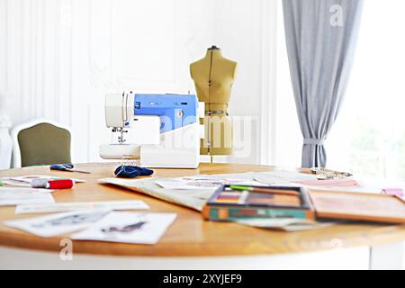 Sewing machine, dummy and other sewing equipment in the desighners workplace Stock Photo
