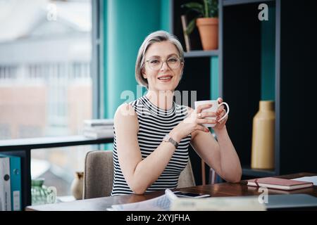 Portrait, mature woman and coffee in office for relax, break or stress management in business as professional. Female person, manager and calm as Stock Photo