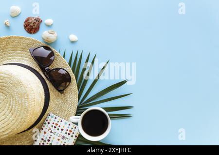 Travel, vacation concept. Hat with sea shells, palm leaf, passport, eyeglasses and cup of coffee on blue background. Stock Photo