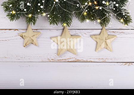 Christmas decorations on white wooden background. Vintage stars and lights, over head view Stock Photo