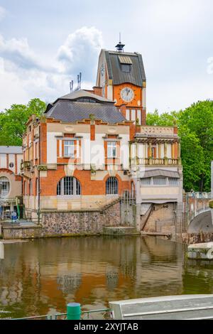 The Hucak hydroelectric power station in Hradec Kralove showcases its stunning Art Nouveau architecture, reflecting the historical significance of early 20th-century engineering by the river's edge. Stock Photo