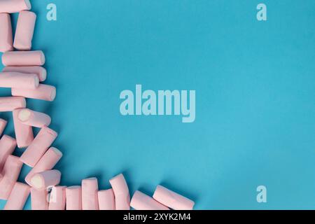 Detailed shot from above showing a disordered heap of marshmallows, primarily covering the left and bottom of the horizontal image. The marshmallows a Stock Photo
