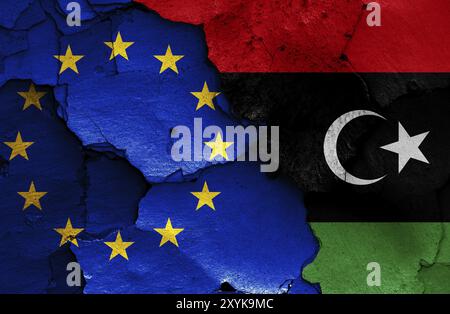 Flags of EU and Libya painted on cracked wall Stock Photo