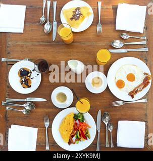 Continental breakfast with pancakes, eggs, bacon, orange jiuce and coffee. Top view Stock Photo