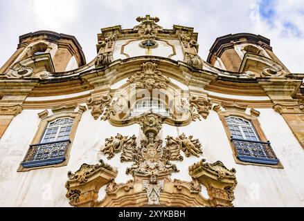 Low angle view of old and historic church in Ouro Preto, Minas Gerais with its windows and baroque sculptures Stock Photo