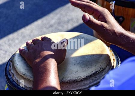 Drum player playing atabaque during presentation of afro music on the eve of the Brazilian carnival Stock Photo