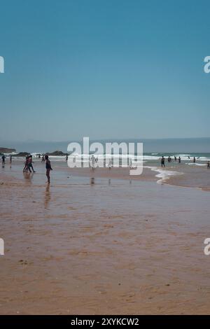 Beach full of people on a sunny summer weekend in Cascais. Stock Photo