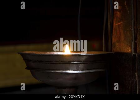 Oil lamps in a Tibetan monastery in Ladakh Stock Photo